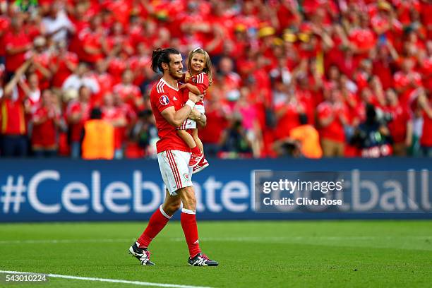 Gareth Bale of Wales celebrates his team's win with his daughter Alba Violet after the UEFA EURO 2016 round of 16 match between Wales and Northern...