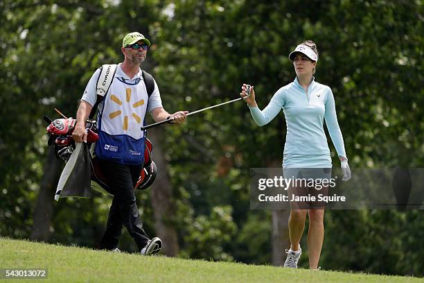 Sandra Gal of Germany hands a club to her caddie after hitting her second shot on the 18th hole during the second round of the Walmart NW Arkansas...