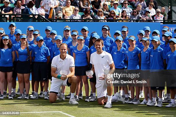 Men's doubles winners Dominic Inglot of Great Britain and Daniel Nestor of Canada pose with their trophies during day six of the ATP Aegon Open...