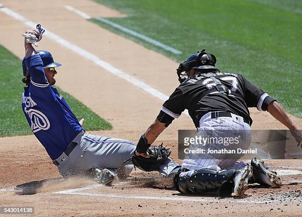 Josh Donaldson of the Toronto Blue Jays is tagged out at the plate by Dioner Navarro of the Chicago White Sox in the 1st inning at U.S. Cellular...