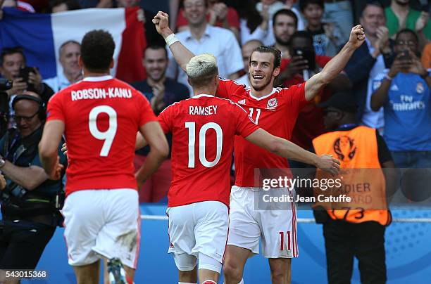 Gareth Bale of Wales celebrates Wales' winning goal with Aaron Ramsey and teammates during the UEFA EURO 2016 round of 16 match between Wales and...