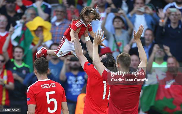 Gareth Bale of Wales celebrates the victory with his daughter Alba Bale on the pitch following the UEFA EURO 2016 round of 16 match between Wales and...