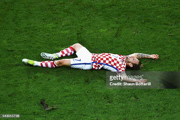 Ivan Rakitic of Croatia lies injured during the UEFA EURO 2016 round of 16 match between Croatia and Portugal at Stade Bollaert-Delelis on June 25,...