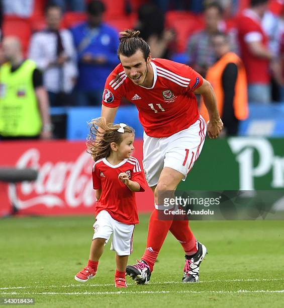 Gareth Bale of Wales and his daughter Alba Violet celebrate after the Euro 2016 round of 16 football match between Wales and North Ireland at Parc...