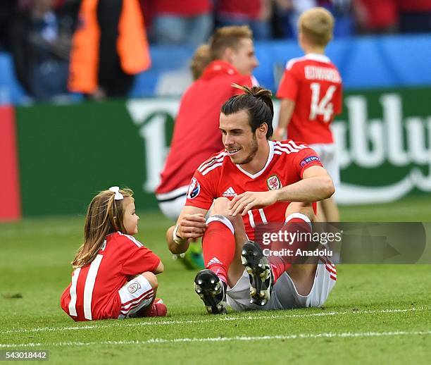 Gareth Bale of Wales and his daughter Alba Violet celebrate after the Euro 2016 round of 16 football match between Wales and North Ireland at Parc...