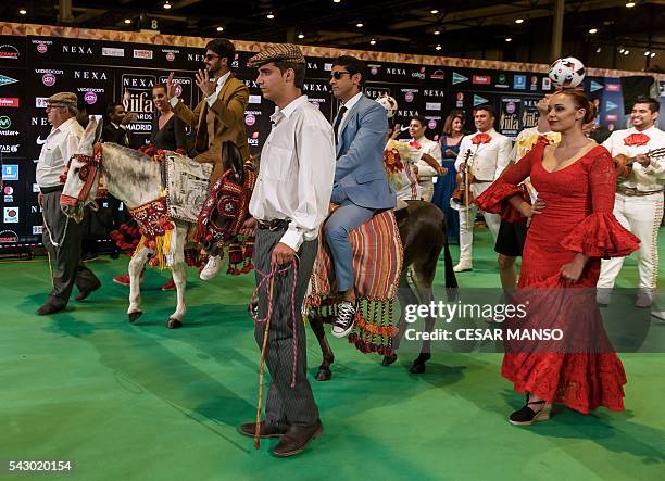 Indian Bollywood actors Shahid Kapoor and Farman Akhtar arrive on donkeys to pose on the green carpet few moments before the 17th edition of IIFA...