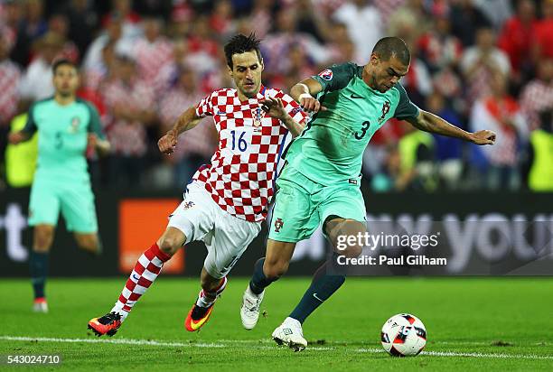 Pepe of Portugal and Pepe of Portugal compete for the ball during the UEFA EURO 2016 round of 16 match between Croatia and Portugal at Stade...