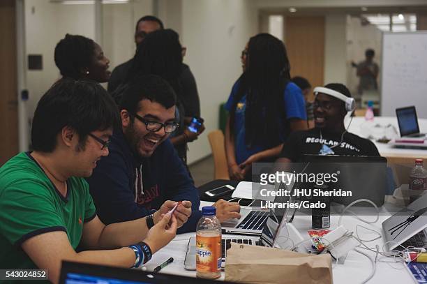 College students laugh and talk as they study in the Brody Learning Commons, a study space and library on the Homewood campus of Johns Hopkins...