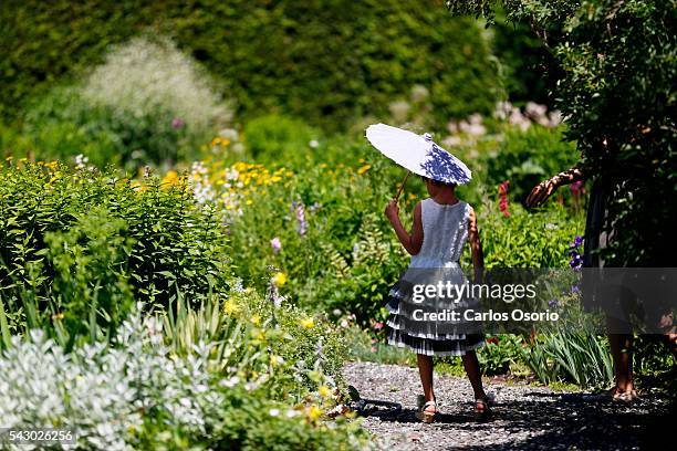 Young girl walks along the garden. Gatsby Garden Party is a revival event at the Spadina Museum based on Scott Fitzgeralds novel The Great Gatsby...