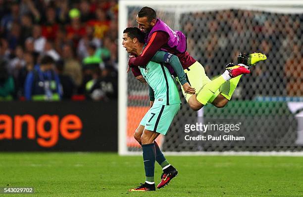 Eduardo of Portugal jumps to his team mate Cristiano Ronaldo to celebrate after their team's 1-0 win in the UEFA EURO 2016 round of 16 match between...