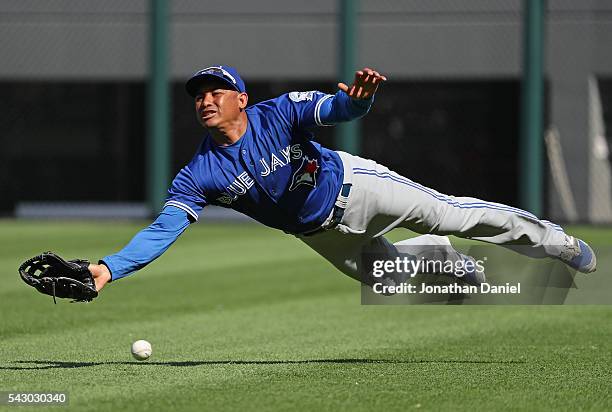 Ezequiel Carrera of the Toronto Blue Jays tries unsuccessfully to make a catch on a ball hit by Jose Abreu of the Chicago White Sox in the 9th inning...