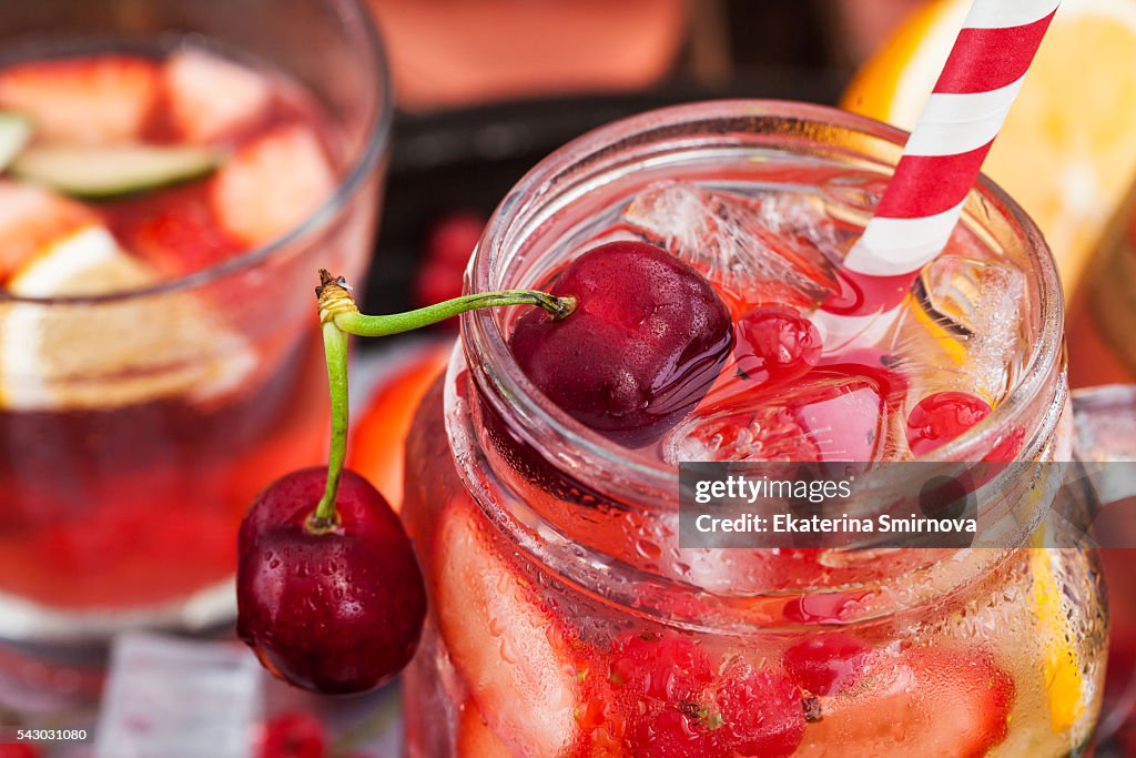 Healthy infused detox water with fresh berries and fruits in mason jar