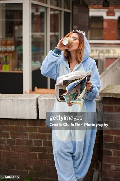 young woman drinking cappuccino in a onesie - sparkdräkt bildbanksfoton och bilder