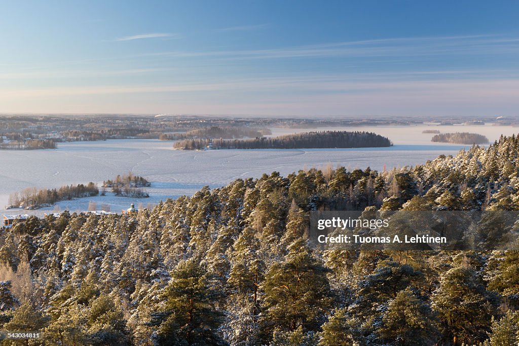 View over snowy trees and frozen lake in Tampere
