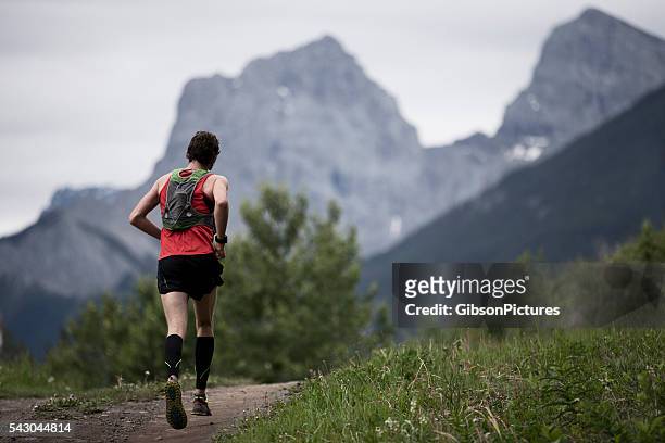 mountain trail runner - knee length stock pictures, royalty-free photos & images