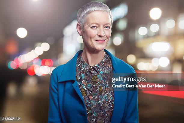 portrait of senior woman in urban city at night. - grey blouse stock pictures, royalty-free photos & images