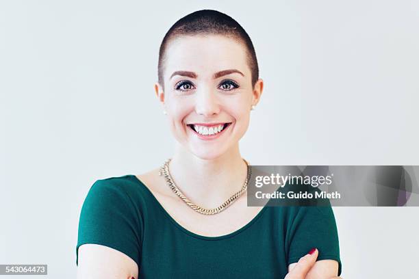 happy smiling young woman. - shaved head stockfoto's en -beelden