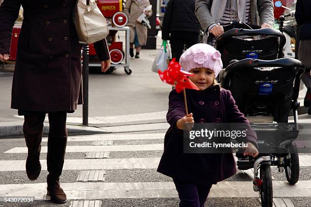 little parisian girl holding a toy windmill - mother stroller stock pictures, royalty-free photos & images