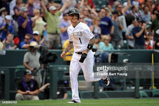Brandon Barnes of the Colorado Rockies rounds third for the score in the sixth inning against the Arizona Diamondbacks at Coors Field on June 25,...