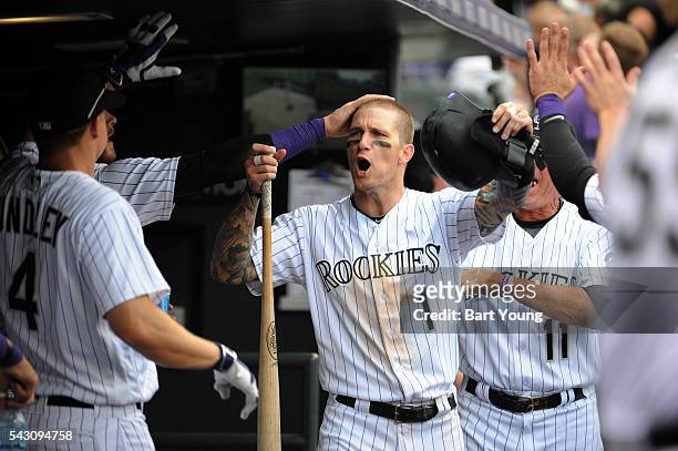 Brandon Barnes of the Colorado Rockies celebrates with his teammates after scoring a run in the sixth inning against the Arizona Diamondbacks at...