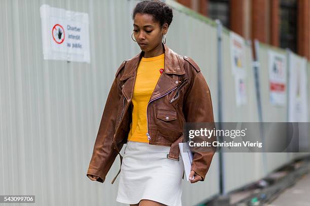 Azza Yousif wearing a brown leather jacket and white mini skirt outside Dior Homme during the Paris Fashion Week Menswear Spring/Summer 2017 on June...