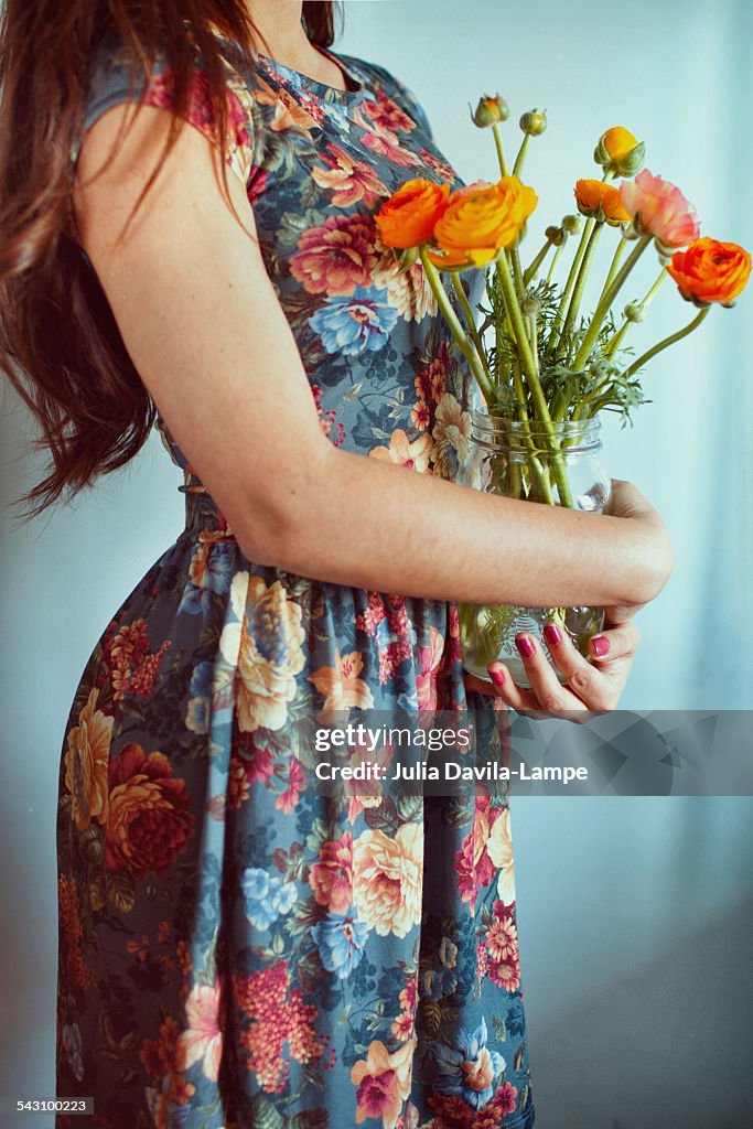 Woman holding a vase with flowers