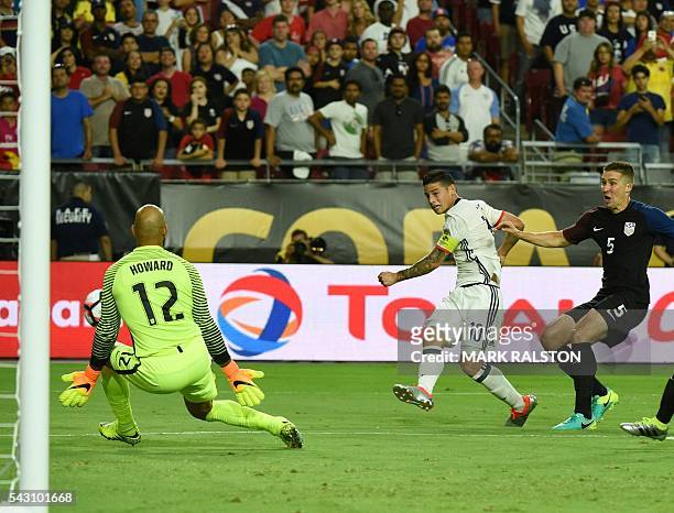 Colombia's James Rodriguez kicks against USA's goalkeeper Tim Howard under the mark of USA's Matt Besler during the Copa America Centenario third...