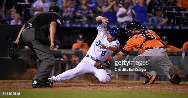 Drew Butera of the Kansas City Royals is tagged out at home by Jason Castro of the Houston Astros as plate umpire Mark Ripperger waits to make the...
