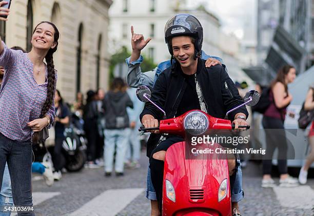 Brazilian model Francisco Lachowski "Chico" and Marlon Teixeira on a red Vespa outside Balmain during the Paris Fashion Week Menswear Spring/Summer...