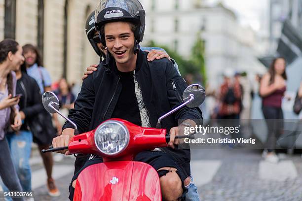 Brazilian model Francisco Lachowski "Chico" and Marlon Teixeira on a red Vespa outside Balmain during the Paris Fashion Week Menswear Spring/Summer...