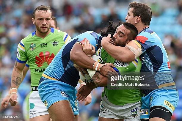 Paul Vaughan of the Raiders is tackled during the round 16 NRL match between the Gold Coast Titans and the Canberra Raiders at Cbus Super Stadium on...