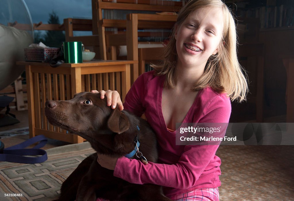 Pre-teen girl and brown lab