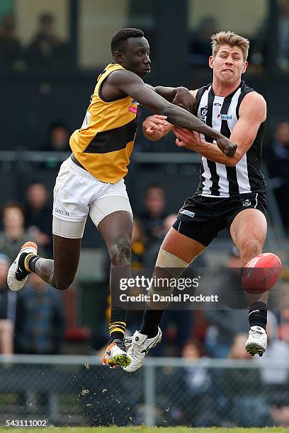 Mabior Chol of the Tigers and Lachlan Howe of the Magpies compete during the round 12 VFL match between the Collingwood Magpies and the Richmond...