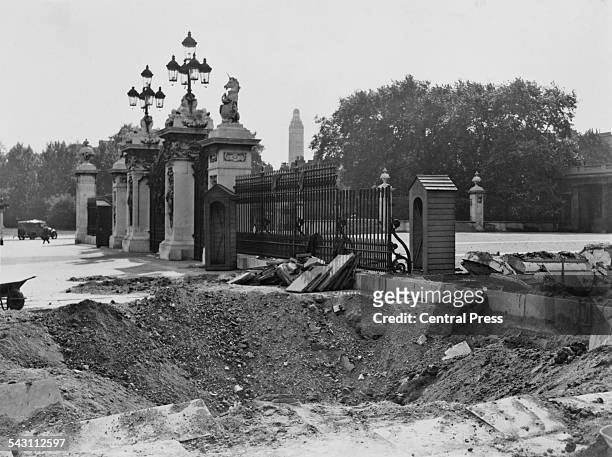 Crater and damaged railings outside Buckingham Palace, London, after the explosion of a German bomb dropped in an air raid the previous day.
