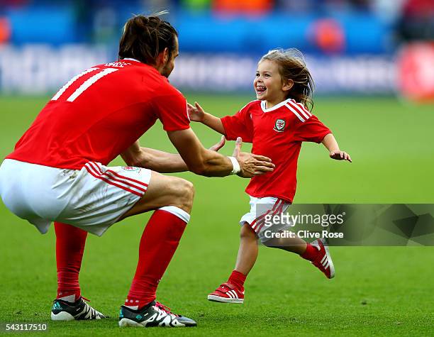 Gareth Bale of Wales celebrates his team's win with his daughter Alba Violet after the UEFA EURO 2016 round of 16 match between Wales and Northern...