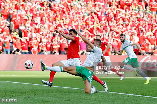 Gareth McAuley of Northern Ireland scores an own goal past Michael McGovern during the UEFA EURO 2016 round of 16 match between Wales and Northern...