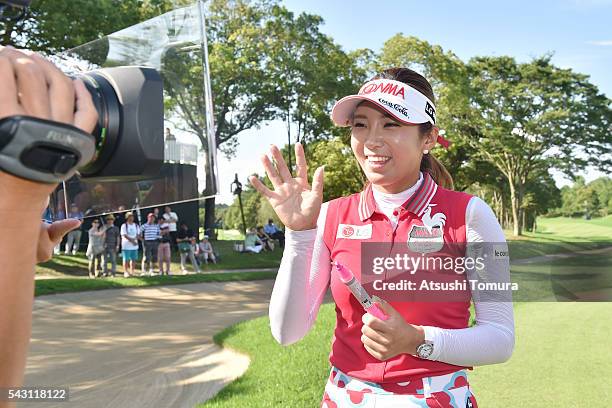 Bo-Mee Lee of South Korea signs an autograph on the TV camera after winning the Earth Mondamin Cup at the Camellia Hills Country Club on June 25,...