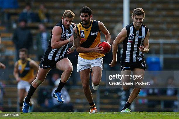 Kelvin Williams of the Tigers runs with the ball during the round 12 VFL match between the Collingwood Magpies and the Richmond Tigers at Victoria...