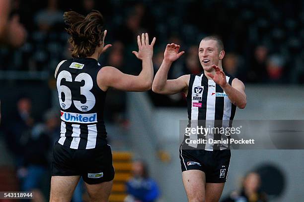 Lachlan Ferguson of the Magpies celebrates with Gus Borthwick of the Magpies after kicking a goal during the round 12 VFL match between the...