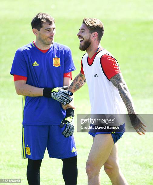 Iker Casillas and Sergio Ramos of Spain share a joke during a training session ahead of their UEFA Euro 2016 round of 16 match against Italy at...