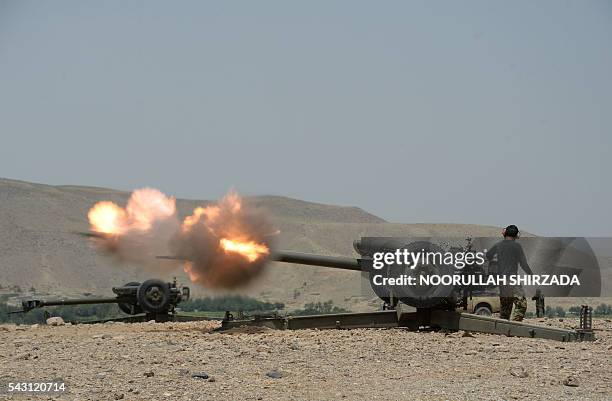 An Afghan National Army soldier fires an artillery shell during ongoing clashes between Afghan security forces and suspected Islamic State militants...