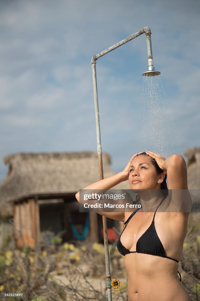 Woman using a shower at a small hotel in the coast of Oaxaca, Mexico.
