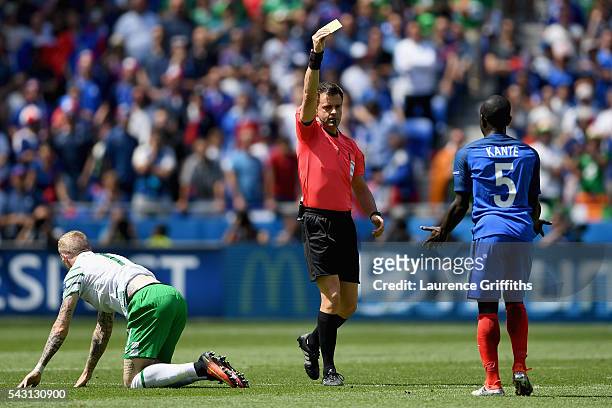 Golo Kante of France is shown a yellow card by referee Nicola Rizzoli after fouling James McClean of Republic of Ireland during the UEFA EURO 2016...