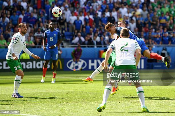 Antoine Griezmann of France heads the ball to score his team's first goal during the UEFA EURO 2016 round of 16 match between France and Republic of...