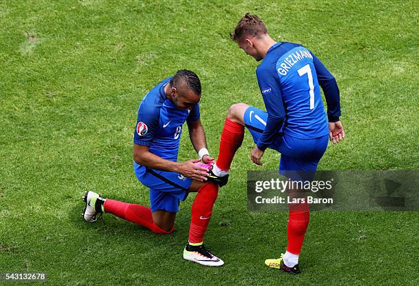 Dimitri Payet of France congratulates his team mate Antoine Griezmann on scoring their team's second goal during the UEFA EURO 2016 round of 16 match...