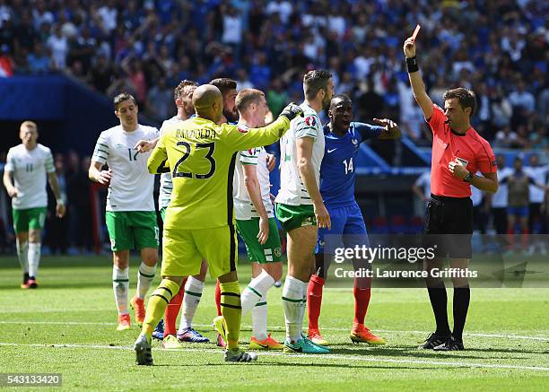 Shane Duffy of Republic of Ireland is shown a red card by referee Nicola Rizzoli during the UEFA EURO 2016 round of 16 match between France and...