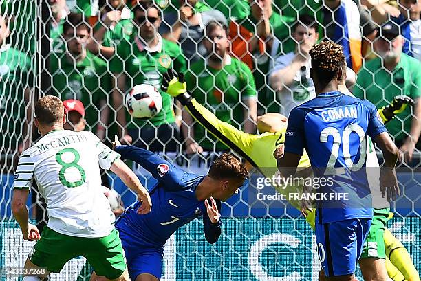 France's forward Antoine Griezmann heads the ball to score against Ireland's goalkeeper Darren Randolph during the Euro 2016 round of 16 football...