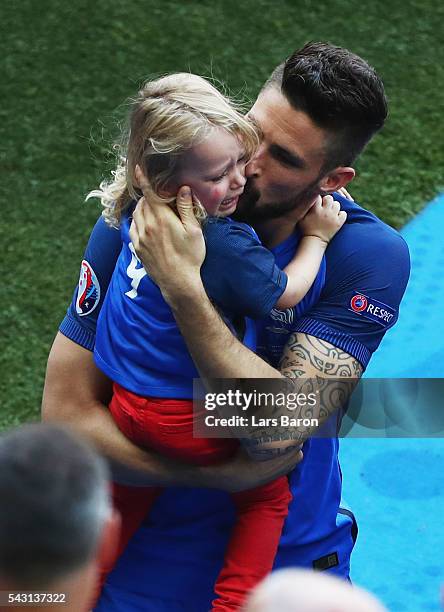 Olivier Giroud of France kisses his daughter Jade to celebrate his team's 2-1 win after the UEFA EURO 2016 round of 16 match between France and...