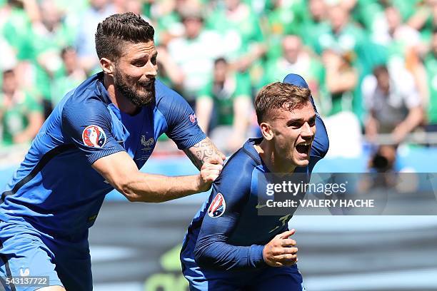 France's forward Antoine Griezmann celebrates scoring a goal next to France's forward Olivier Giroud during the Euro 2016 round of 16 football match...