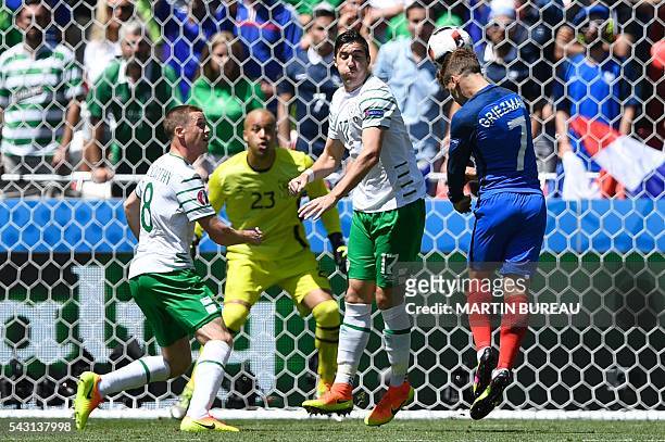 France's forward Antoine Griezmann heads the ball during the Euro 2016 round of 16 football match between France and Republic of Ireland at the Parc...